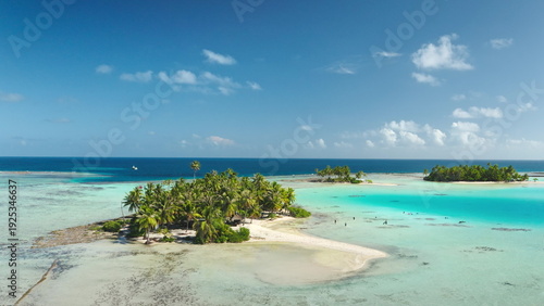 Photos French Polynesia, Rangiroa islands: Aerial view tourists swimming in turquoise lagoon surrounded by white sand beach and palm trees