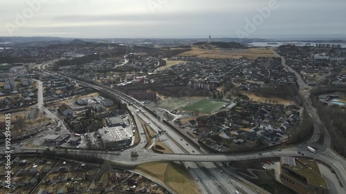 Wallpaper Mural Aerial drone footage showing vehicle traffic moving through a suburban area in Norway during late winter. The scene captures residential neighborhoods, roads, and surrounding landscape under cold seas Torontodigital.ca