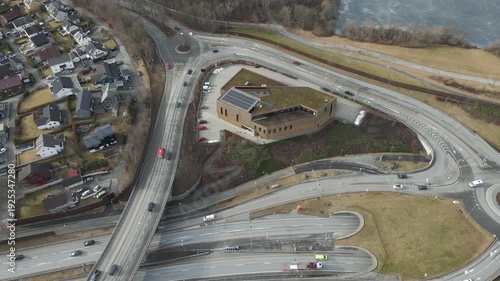Wallpaper Mural Aerial drone footage showing vehicle traffic moving through a suburban area in Norway during late winter. The scene captures residential neighborhoods, roads, and surrounding landscape under cold seas Torontodigital.ca