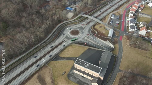 Wallpaper Mural Aerial drone footage showing vehicle traffic moving through a suburban area in Norway during late winter. The scene captures residential neighborhoods, roads, and surrounding landscape under cold seas Torontodigital.ca