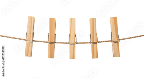 Five wooden clothespins hanging on a clothesline, ready to dry the laundry