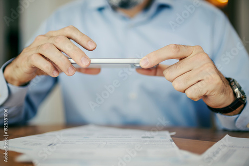 Obraz na płótnie Person using smartphone for mobile banking depositing check