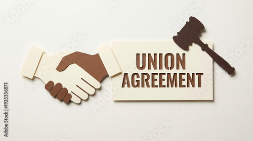 Union agreement concept with paper cut handshake and judge gavel symbolizing legal contract and cooperation in labor relations