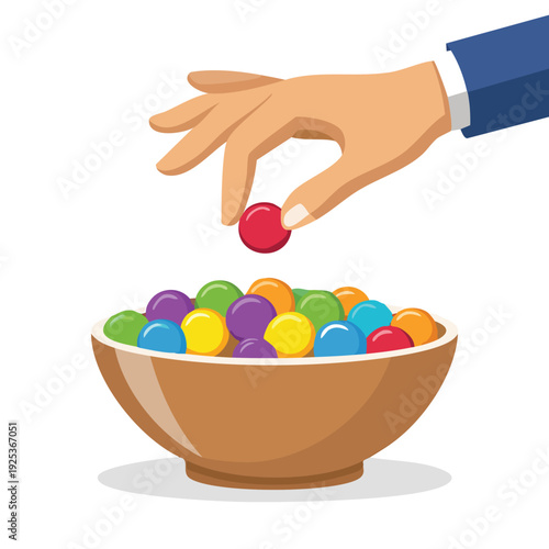 Hand selecting colorful ball from a bowl