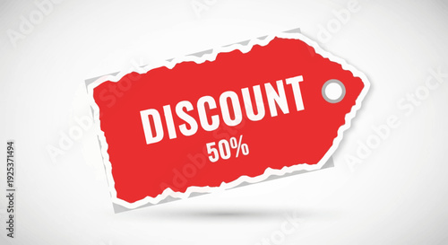 Red discount label with torn edge and 50 percent text on white background viewed from directly above