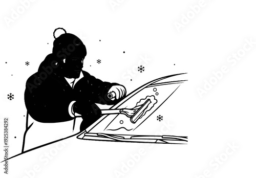 Person scraping ice off car windshield in snowy weather