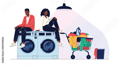 Man and woman sit on top of washing machines in a laundry room next to a shopping cart overflowing with colorful clothes and detergent.