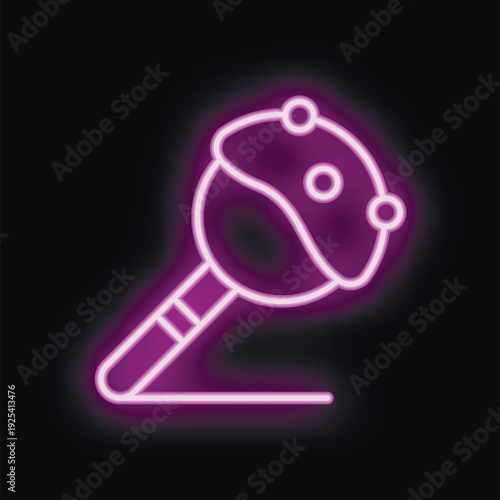 Neon sign of a cake pop is glowing purple on this black background