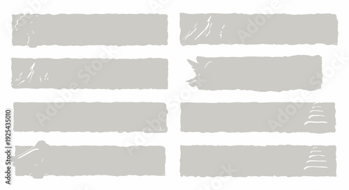 Collection of torn paper strips with rough edges and various textures.