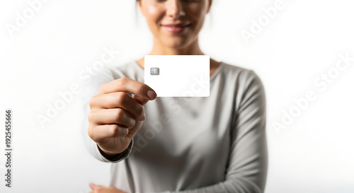 Woman holding blank business card in focus, close-up view, professional gesture, studio environment, minimalistic background, marketing concept