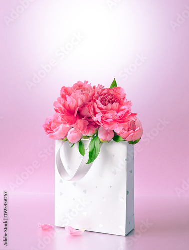 Beautiful gift box with pink peonies. Concept of internet shopping, flower shop. Mothers or Women's Day.