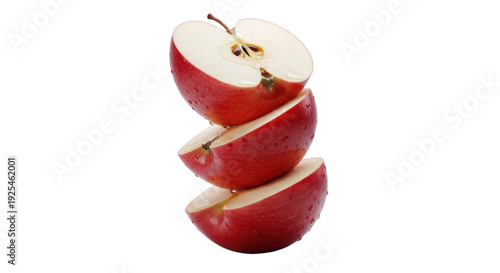 Stack of three red apple halves with visible seeds and core on a white background