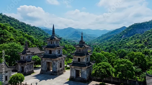 Ancient Pagoda Structures Surrounded by Lush Green Mountains and Blue Sky