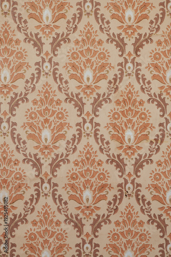 Old wallpaper on the wall. Old wallpaper for texture or background.