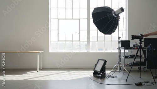 Minimalist photography studio interior showcasing professional lighting equipment and camera on tripod setup