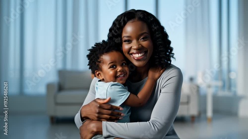 Happy Mother Embracing Her Adorable Child With Love and Joy Indoors