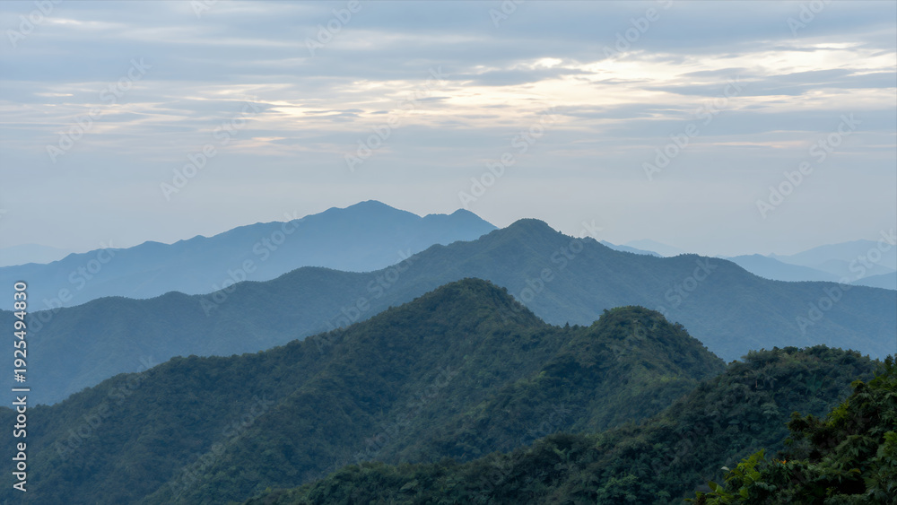 Fototapeta premium Panoramic View Of Layered Mountains Under A Cloudy Sky During Daylight