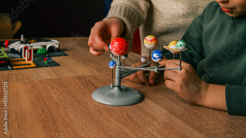 Foto Children learning about the solar system with a model planetarium and educationa