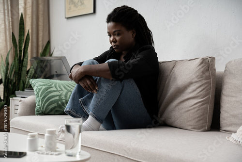 Εκτύπωση καμβά Overwhelmed by sadness, a woman finds solace in her quiet home environment
