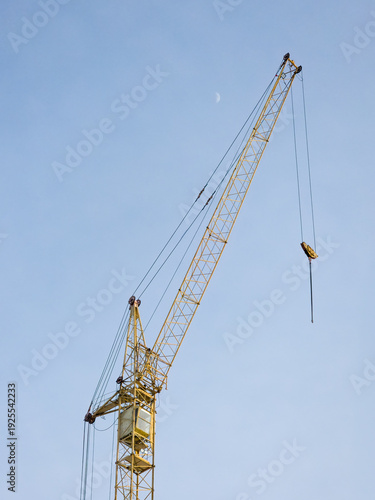 Tall Yellow Crane Against Blue Sky