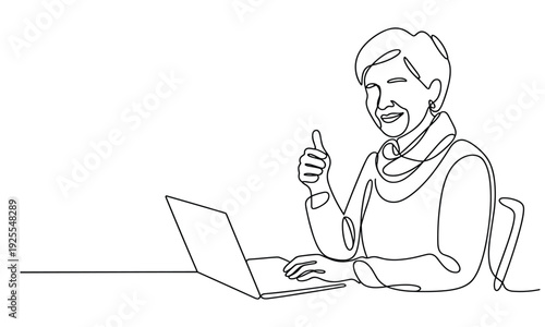 Elderly woman using laptop and giving thumbs up gesture