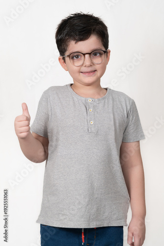 Smiling Boy in Glasses Giving a Thumbs Up