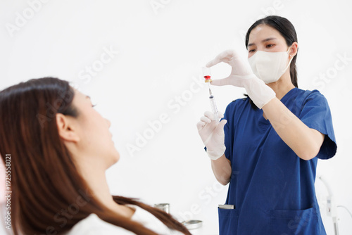 A woman is getting a shot in her face. A nurse is holding a syringe and preparing to give her the shot

