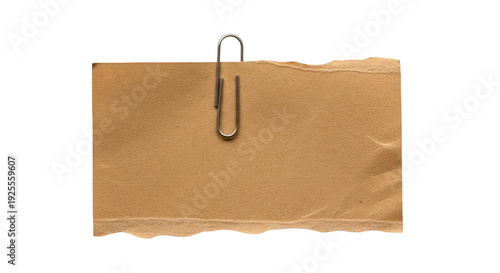 Brown paper note with metal paperclip on black background, simple office stationery