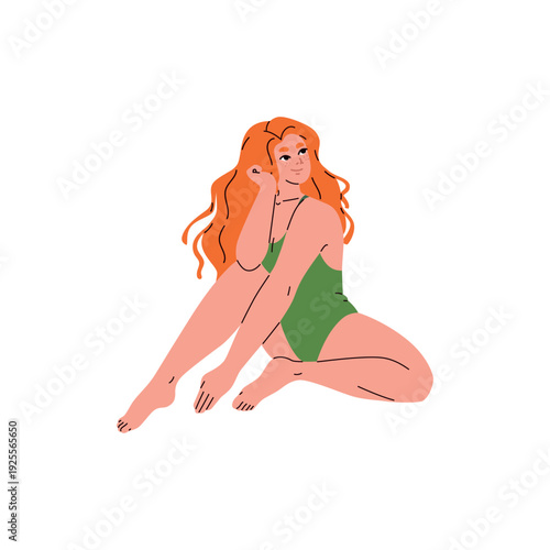 A young red-haired woman in a swimsuit sitting and looking away