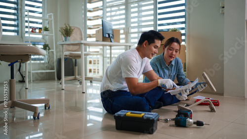 Tableau sur toile Asian adult couple assembling furniture at new home DIY project teamwork relocat
