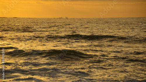 Sunset with orange colours over the calm ocean.