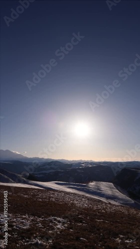 Mountain landscape at sunset or sunrise. View of the snowy peaks of Elbrus. Vertical video