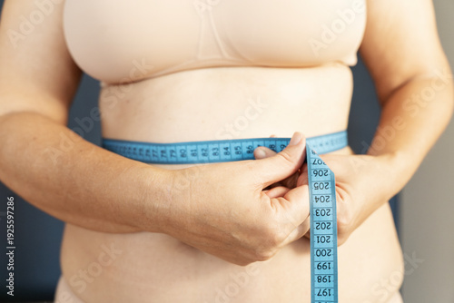 Принти на полотні Woman measuring waist with tape for weight loss
