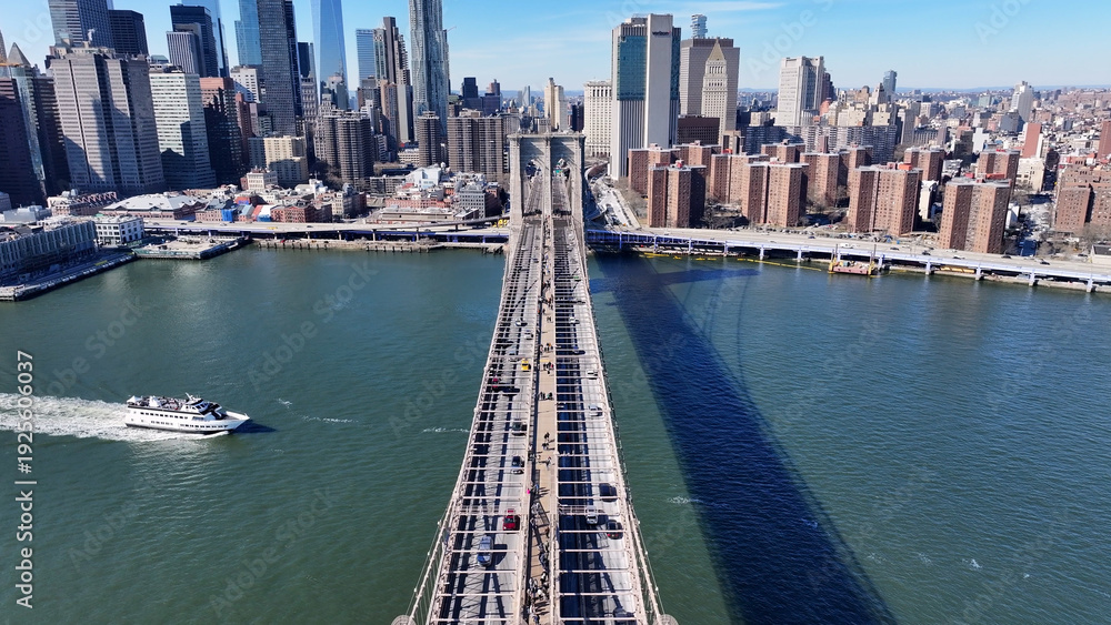 Obraz premium Brooklyn Bridge In Manhattan New York United States. Birds Eye View Of Suspension Bridge With Cars Driving Across. Business Sky Downtown Cityscape. Business Downtown Panorama. Manhattan New York.