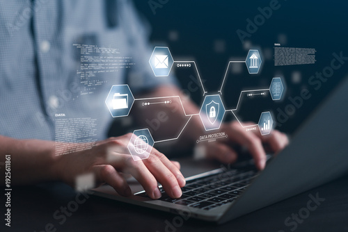 Close up of man typing on laptop keyboard with virtual data protection shield and encryption icons. Concept of cybersecurity software, secure cloud storage, and privacy coding.