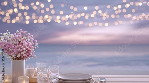 Romantic table setting with flowers and candles by the ocean at dusk