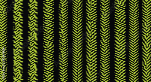 Vertical rows of green, chevron-like patterns on a black background create a repeating, textured design. The arrangement is orderly and geometric.