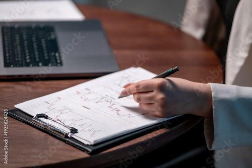 Bild auf Leinwand Businesswoman preparing financial forecast in evening office with laptop