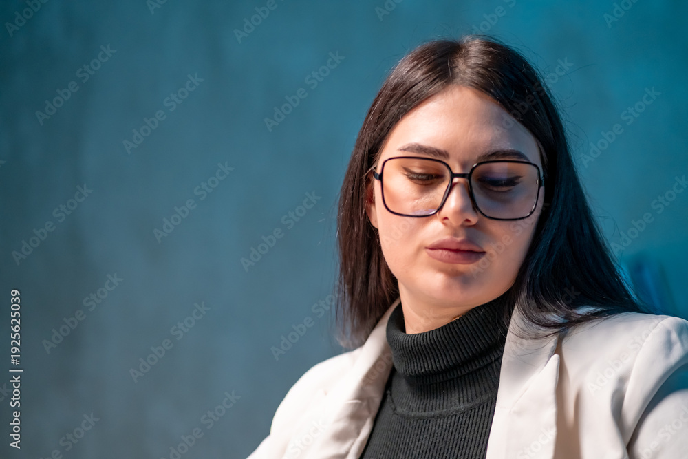Fototapeta premium Tired office worker concentrating on paperwork. Concept of professional workload. 