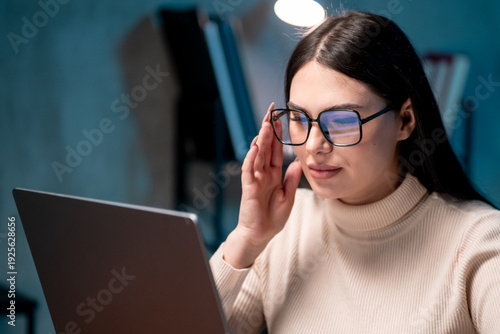 Quadro em tela Female professional concentrating on laptop work at office desk