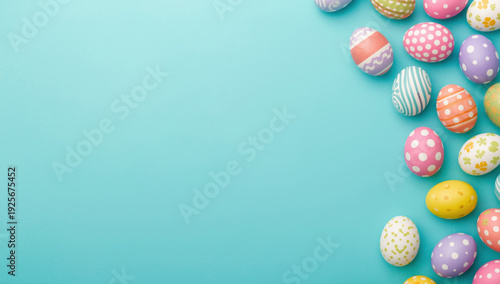 Colorful easter eggs on turquoise background with happy easter text and bunny ears colorful eggs