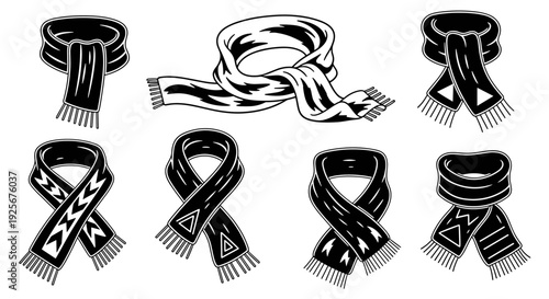 Collection of various black and white scarves with different patterns and styles.
