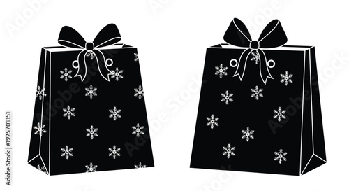 Two black gift boxes with white snowflake patterns and ribbon bows