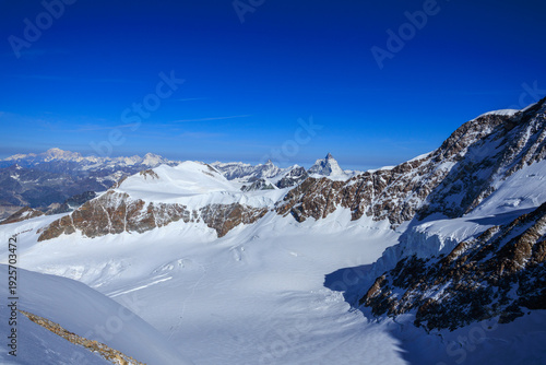 Mountain glacier panorama with summit Castor (foreground), Mont Blanc massif (background left) and Matterhorn (background right) in Pennine Alps, Italy