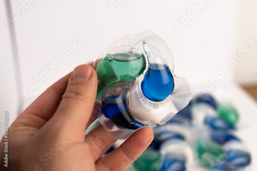 Close-up of a laundry pod with blue and green liquid detergent