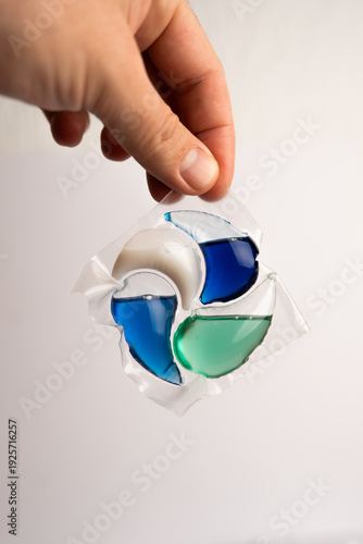Close-up of a laundry pod with blue and green liquid detergent
