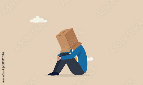 Business mistake misfortune and unlucky, bankruptcy or fail entrepreneur concept, depressed businessman sitting covered his head with box, shameful cannot face people or society.
