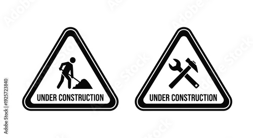 Two triangular warning signs depicting construction workers and tools