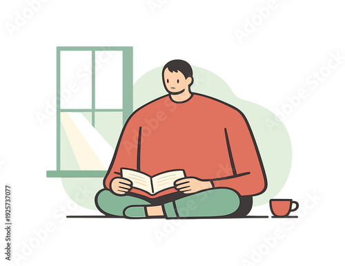 Person sitting cross-legged by the window reading a book with a cup of tea