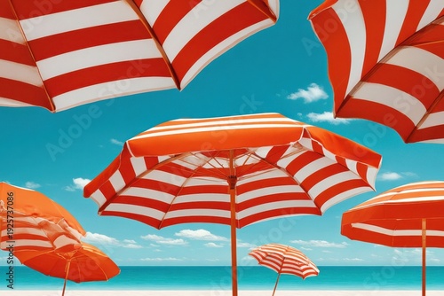 Red and white striped beach umbrellas on a sunny turquoise ocean shore for summer relaxation